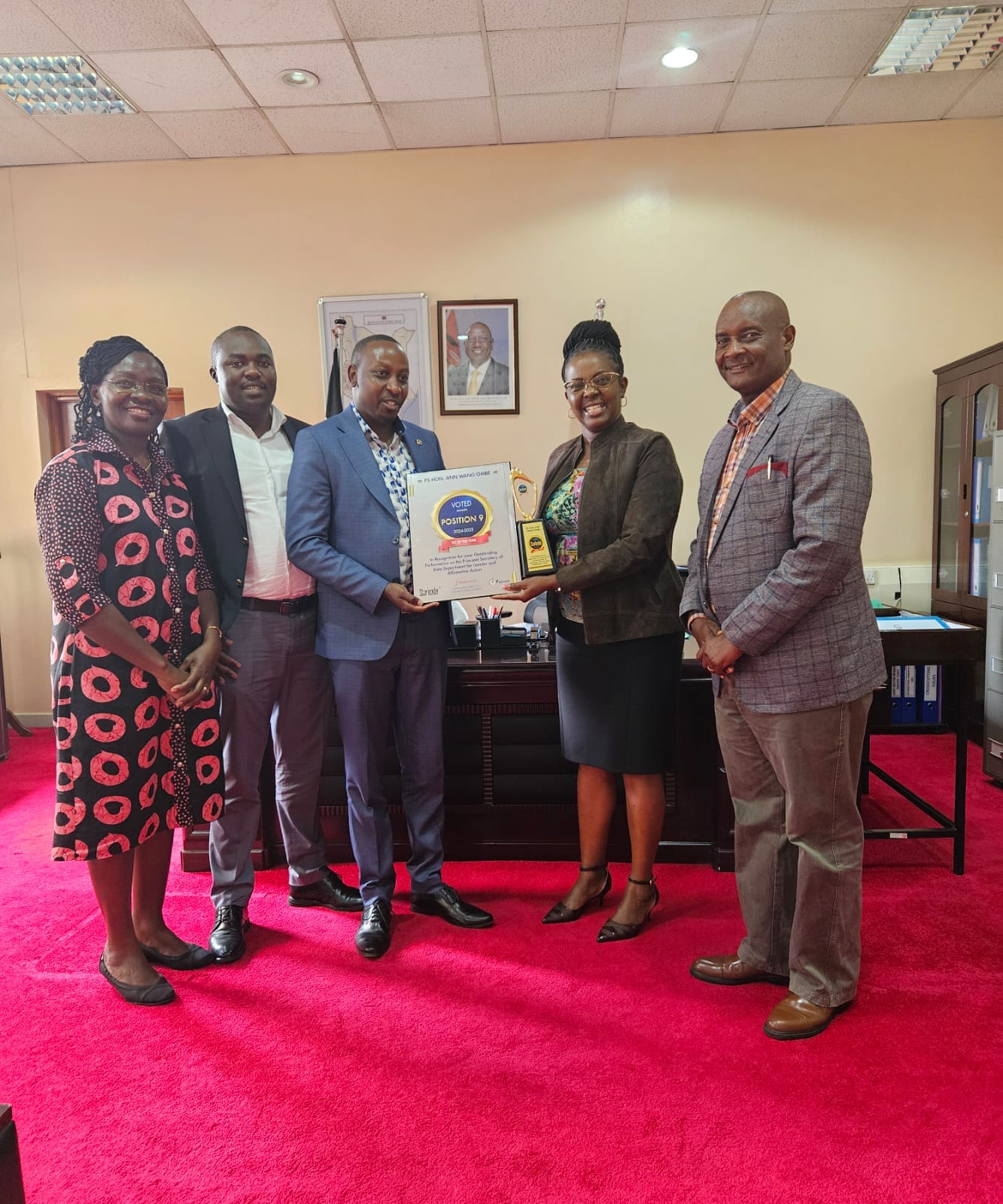 PS Anne Wangómbe received her congratulatory plaque from Politrack Africa flanked by the Secretary Gender Dr. Josephine Obonyo (far left) and the Secretary Administration (far right) Moses Ivuto. 