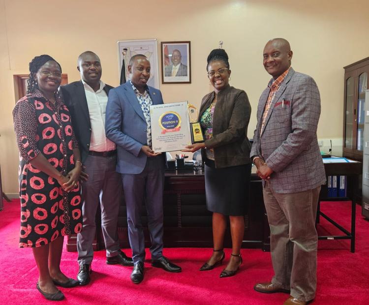 PS Anne Wangómbe received her congratulatory plaque from Politrack Africa flanked by the Secretary Gender Dr. Josephine Obonyo (far left) and the Secretary Administration (far right) Moses Ivuto. 